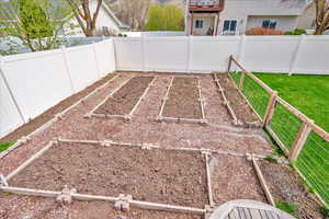 View of yard with a fenced backyard and a garden