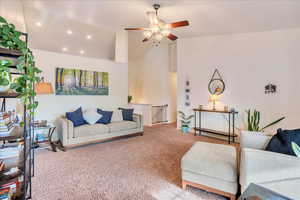 Carpeted living room featuring recessed lighting, a ceiling fan, and high vaulted ceiling