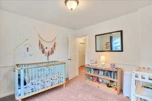 Bedroom with baseboards and carpet flooring