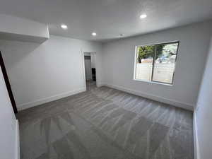 Unfurnished room featuring baseboards, recessed lighting, carpet, and a textured ceiling