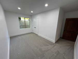 Carpeted empty room with recessed lighting, baseboards, and visible vents