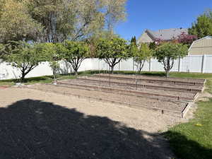View of yard with a fenced backyard and a garden