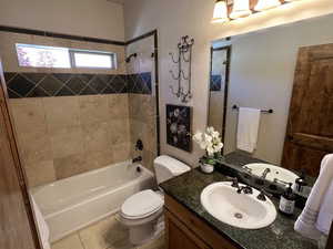 Full bathroom featuring toilet, shower / washtub combination, tile patterned flooring, and vanity