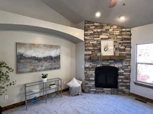 Living area with carpet flooring, vaulted ceiling, and visible vents