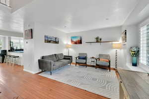 Living area featuring baseboards, hardwood / wood-style floors, and a wealth of natural light