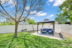 View of yard featuring a fenced backyard, a gazebo, an outdoor living space, and a patio area