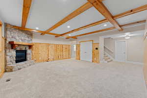Unfurnished living room with recessed lighting, baseboards, stairs, and beamed ceiling