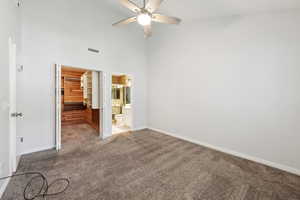 Unfurnished bedroom with carpet floors, baseboards, a spacious closet, visible vents, and a closet
