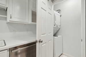Laundry room featuring laundry area and stacked washer and dryer
