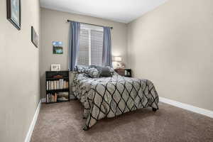Bedroom with carpet floors and baseboards