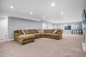 Living room featuring recessed lighting, baseboards, and light carpet