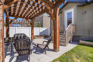 View of patio / terrace featuring a fire pit, fence, and a pergola