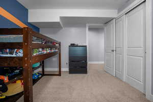 Carpeted bedroom featuring baseboards