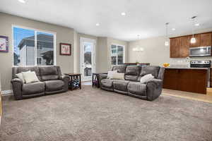 Living room featuring plenty of natural light, recessed lighting, a textured ceiling, and a chandelier