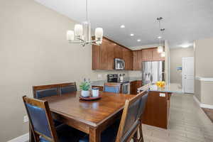 Dining room with recessed lighting, baseboards, and an inviting chandelier