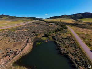 Aerial view featuring a water and mountain view
