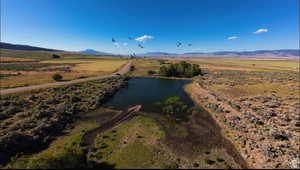 Drone / aerial view featuring a rural view and a water and mountain view