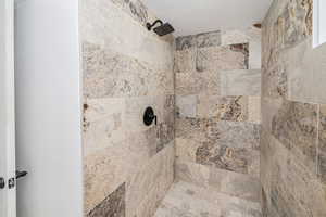 Interior details with a textured ceiling and a tile shower