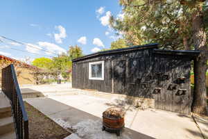 View of outbuilding featuring fence