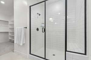 Full bathroom featuring baseboards and a shower stall