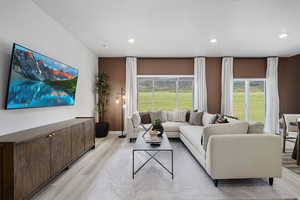 Living area featuring light wood-type flooring, recessed lighting, and a textured ceiling