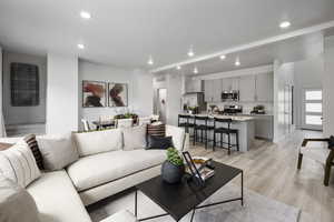 Living area with baseboards, recessed lighting, light wood-style flooring, and visible vents