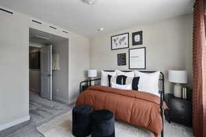 Bedroom with carpet floors, baseboards, and visible vents