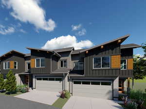 View of front of home featuring a garage, board and batten siding, and driveway