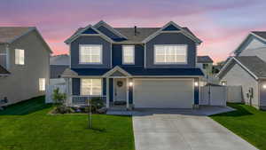View of front of house featuring a garage, board and batten siding, fence, and concrete driveway