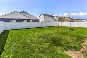 View of yard featuring a fenced backyard and a residential view