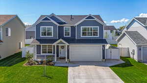 View of front of house featuring covered porch, board and batten siding, fence, an attached garage, and a shingled roof