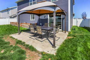 View of patio featuring a fenced backyard and a gazebo