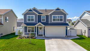 View of front of property with fence, board and batten siding, a porch, and driveway