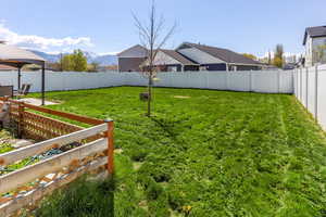 View of yard featuring a fenced backyard, a mountain view, and a gazebo