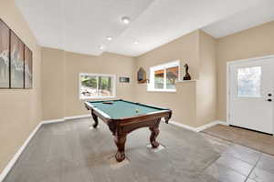 Playroom with billiards, baseboards, carpet, and a textured ceiling