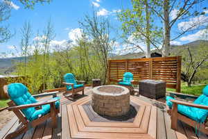 Deck featuring a mountain view and a fire pit