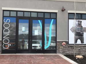 Entrance to property with stucco siding, french doors, and stone siding