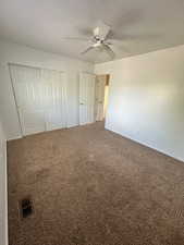 Unfurnished bedroom with visible vents, carpet flooring, baseboards, and a closet