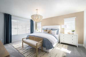 Bedroom with an inviting chandelier, carpet, baseboards, and multiple windows