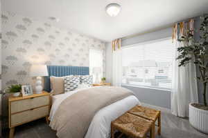 Carpeted bedroom with a textured ceiling, wallpapered walls, and baseboards