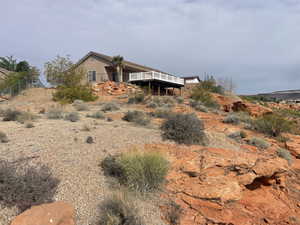 Exterior space with a wooden deck and stucco siding