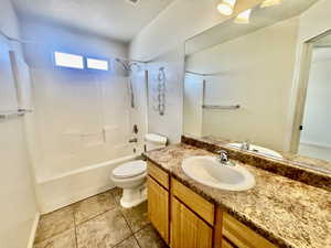 Full bath with toilet, shower / bath combination, tile patterned floors, and vanity