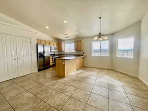 Kitchen featuring appliances with stainless steel finishes, a sink, a peninsula, recessed lighting, and light tile patterned floors