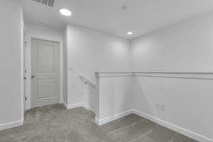 Walk in closet with visible vents and carpet