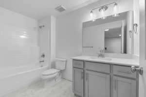 Bathroom with visible vents, vanity, marble finish floor, toilet, and  shower combination