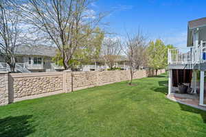 View of yard with fence and deck