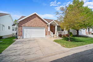 Ranch-style house featuring a front lawn, covered porch, concrete driveway, brick siding, and an attached garage