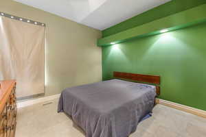 Tiled bedroom with visible vents and baseboards