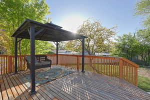 Wooden deck featuring a gazebo