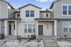 Townhome / multi-family property featuring brick siding and cooling unit